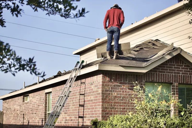 Professional roofer working on a residential roof in Manchaca